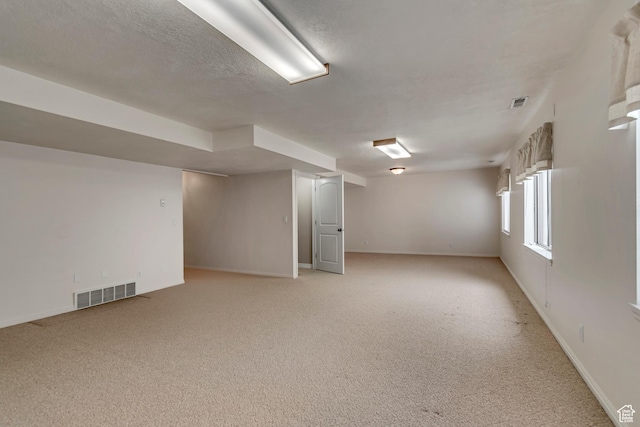 10976 Quartz Dr, South Jordan, UT 84095 - basement with visible vents, baseboards, light colored carpet, and a textured ceiling