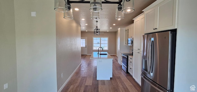 854 N 1880 E Unit 72, Price, UT 84501 - kitchen featuring pendant lighting, a center island with sink, white cabinets, sink, and stainless steel appliances