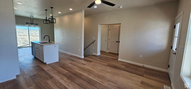 854 N 1880 E Unit 72, Price, UT 84501 - kitchen with ceiling fan, a kitchen island with sink, sink, white cabinetry, and hanging light fixtures