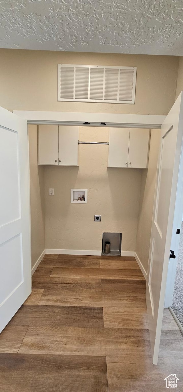 854 N 1880 E Unit 72, Price, UT 84501 - laundry area with cabinets, light hardwood / wood-style flooring, washer hookup, a textured ceiling, and hookup for an electric dryer