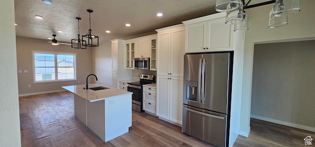 854 N 1880 E Unit 72, Price, UT 84501 - kitchen with ceiling fan, sink, a center island with sink, white cabinets, and appliances with stainless steel finishes