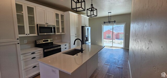 1840 E 840 N Unit 81, Price, UT 84501 - kitchen with appliances with stainless steel finishes, a kitchen island with sink, sink, decorative light fixtures, and white cabinets