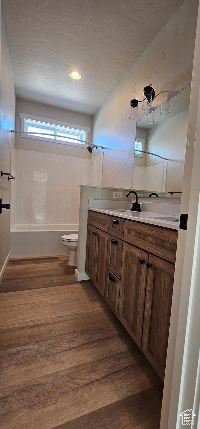 1840 E 840 N Unit 81, Price, UT 84501 - full bathroom featuring vanity,  shower combination, a textured ceiling, hardwood / wood-style floors, and toilet