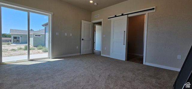 1840 E 840 N Unit 81, Price, UT 84501 - unfurnished bedroom featuring carpet, a barn door, access to outside, and multiple windows