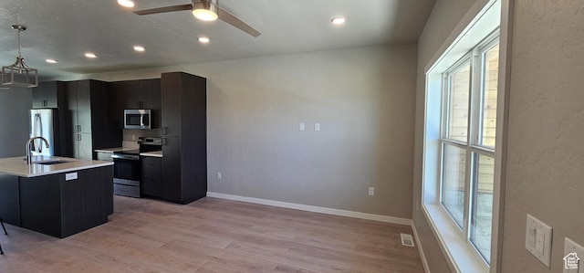 1843 E 840 N Unit 86, Price, UT 84501 - kitchen with hanging light fixtures, sink, a healthy amount of sunlight, and appliances with stainless steel finishes