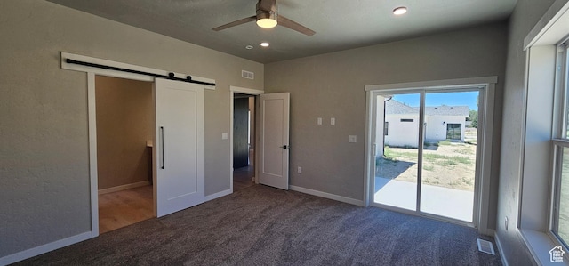 1843 E 840 N Unit 86, Price, UT 84501 - unfurnished bedroom featuring access to outside, a barn door, ceiling fan, and carpet flooring