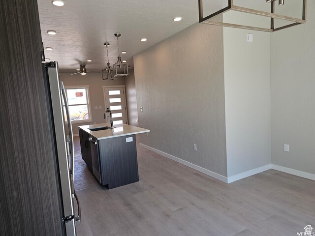 1858 E 840 N Unit 82, Price, UT 84501 - kitchen featuring pendant lighting, sink, hardwood / wood-style flooring, an island with sink, and stainless steel appliances