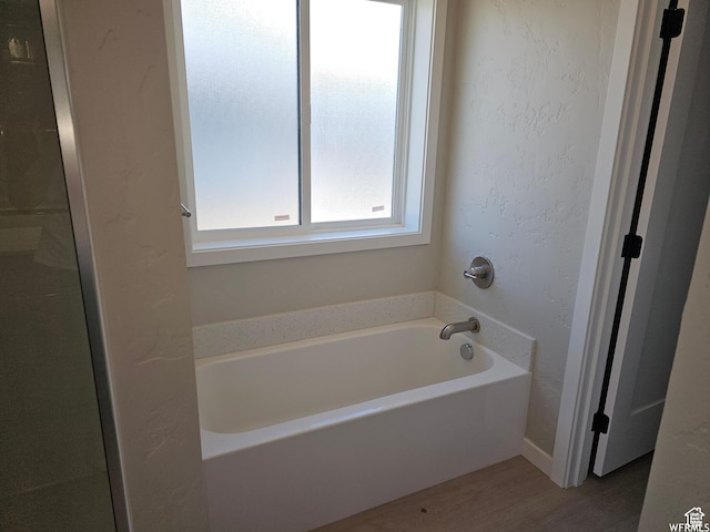 1858 E 840 N Unit 82, Price, UT 84501 - bathroom with a washtub and hardwood / wood-style flooring