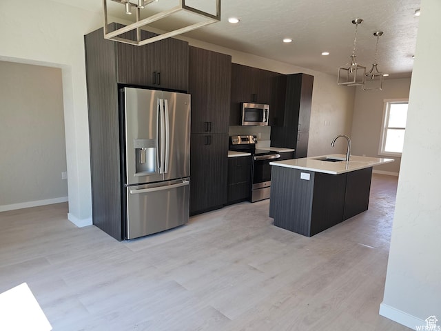 1858 E 840 N Unit 82, Price, UT 84501 - kitchen with sink, hanging light fixtures, light hardwood / wood-style floors, a kitchen island with sink, and appliances with stainless steel finishes