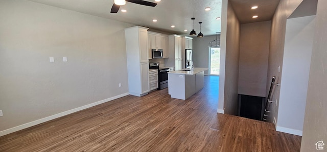 1829 E 840 N Unit 87, Price, UT 84501 - kitchen featuring appliances with stainless steel finishes, a kitchen island with sink, sink, decorative light fixtures, and white cabinetry