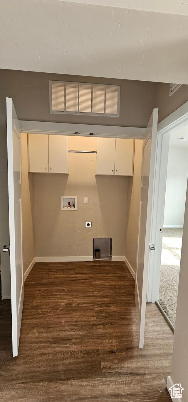 clothes washing area with dark hardwood / wood-style flooring, hookup for a washing machine, cabinets, and hookup for an electric dryer