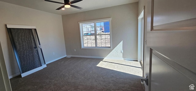 carpeted spare room with ceiling fan