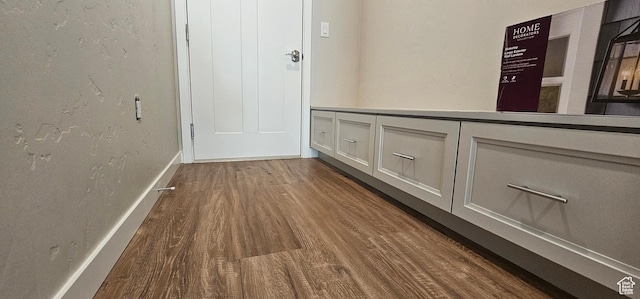 corridor with dark hardwood / wood-style floors