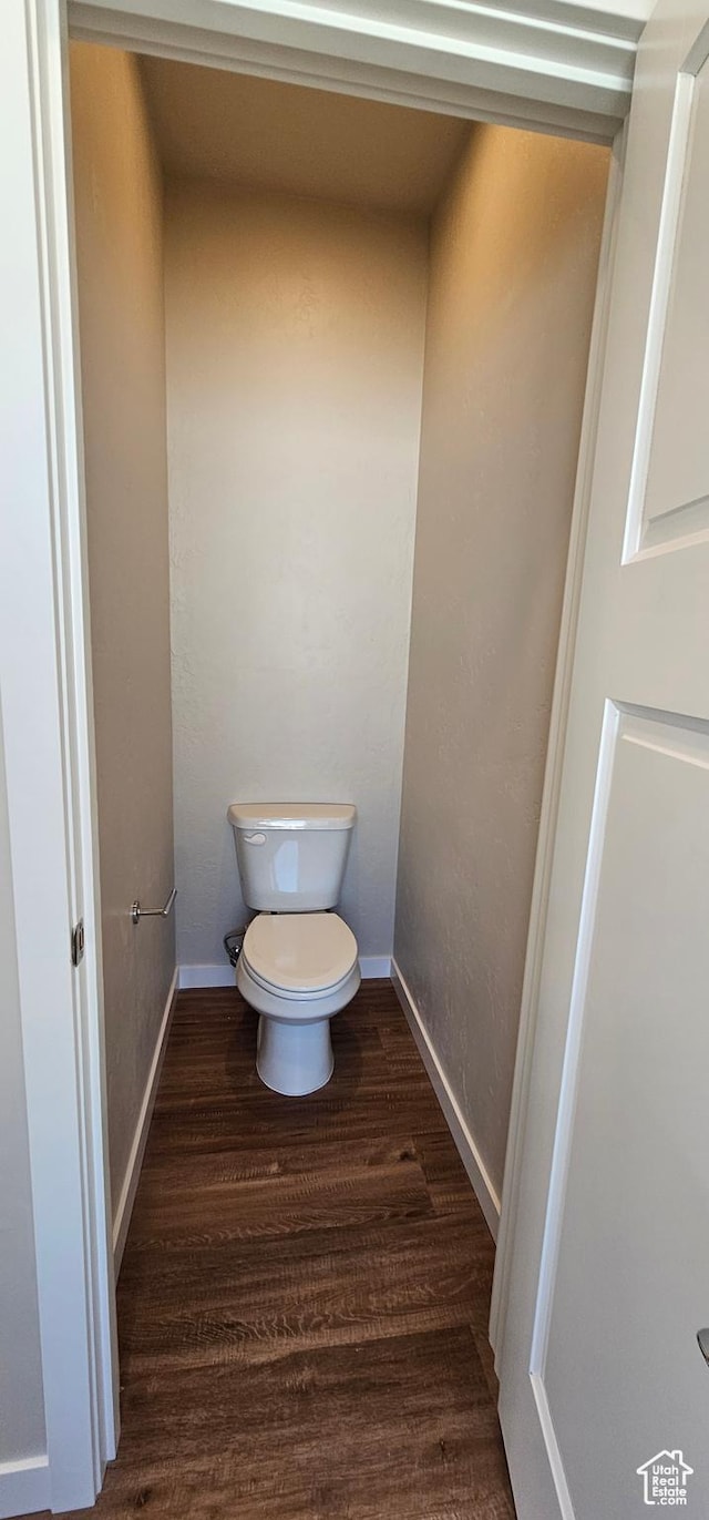 bathroom featuring hardwood / wood-style flooring and toilet