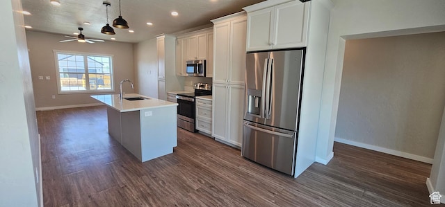 kitchen with white cabinets, sink, an island with sink, and appliances with stainless steel finishes