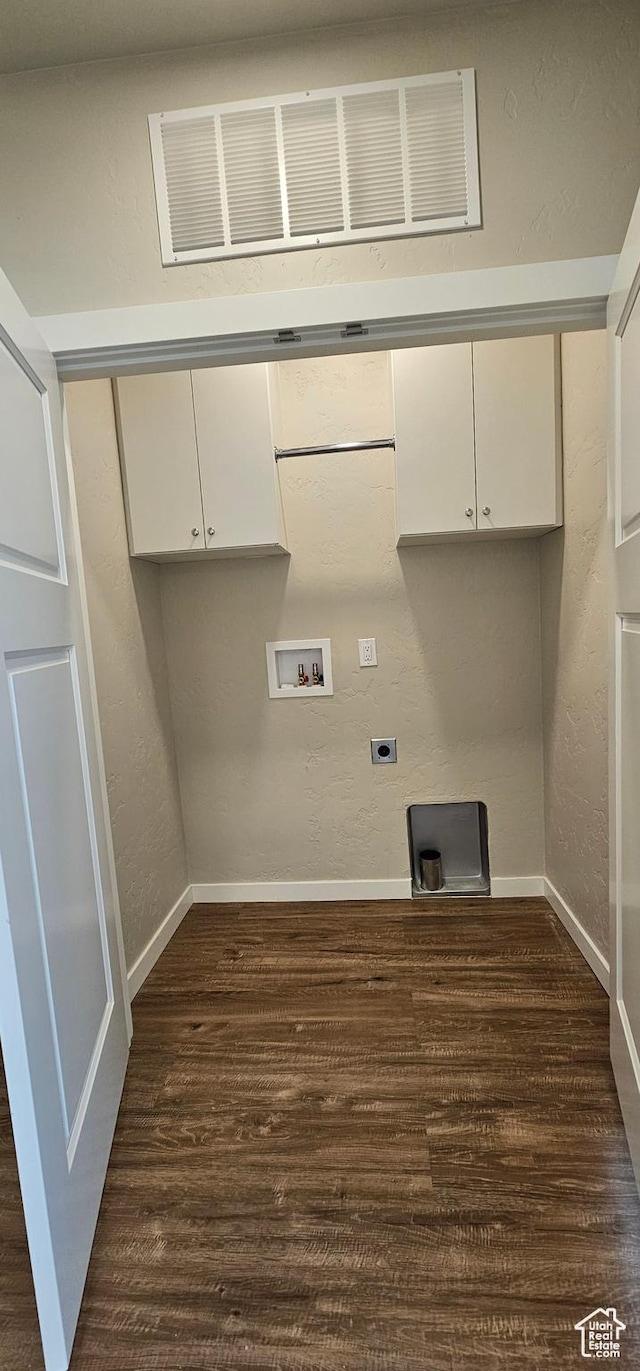 laundry area featuring electric dryer hookup, dark wood-type flooring, cabinets, and washer hookup
