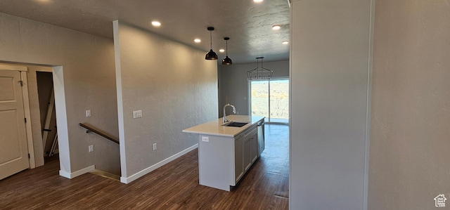 868 N 1880 E Unit 71, Price, UT 84501 - kitchen with dark wood-type flooring, sink, a center island with sink, white cabinets, and hanging light fixtures
