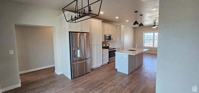 868 N 1880 E Unit 71, Price, UT 84501 - kitchen with stainless steel appliances, ceiling fan, pendant lighting, a center island with sink, and white cabinetry