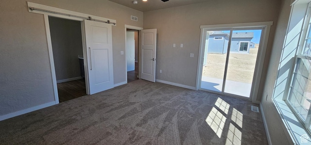 1830 E 840 N Unit 80, Price, UT 84501 - interior space featuring dark carpet, access to exterior, and a barn door