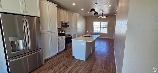 1830 E 840 N Unit 80, Price, UT 84501 - kitchen featuring appliances with stainless steel finishes, a kitchen island with sink, dark wood-type flooring, ceiling fan, and decorative light fixtures