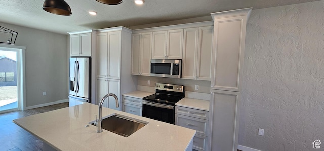 1830 E 840 N Unit 80, Price, UT 84501 - kitchen featuring white cabinetry, sink, a kitchen island with sink, and appliances with stainless steel finishes