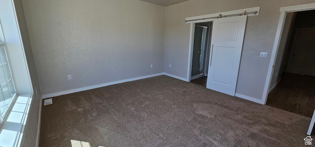 1830 E 840 N Unit 80, Price, UT 84501 - unfurnished bedroom featuring dark colored carpet and a barn door