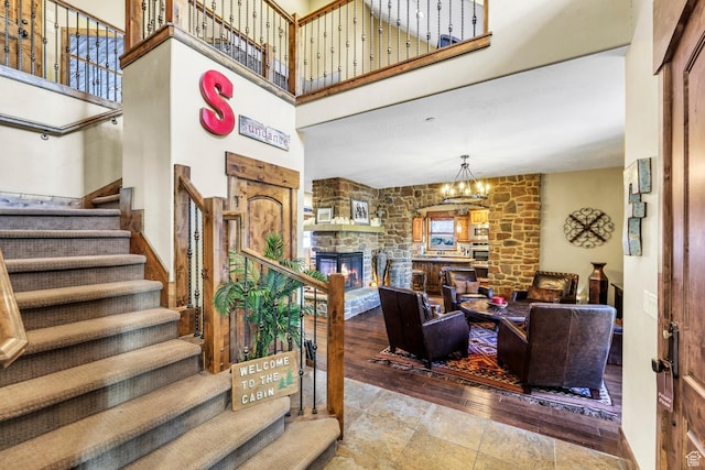 9049 N Timphaven Rd, Sundance, UT 84604 - living room featuring a stone fireplace, a high ceiling, and an inviting chandelier