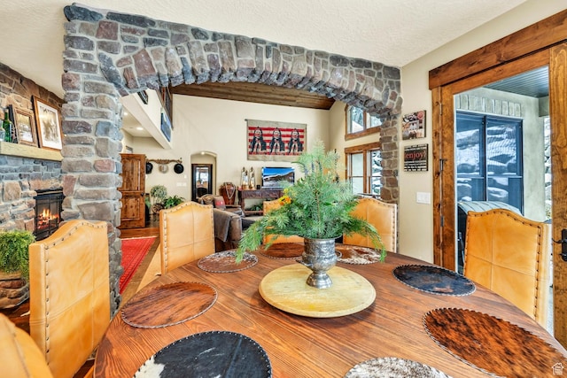 9049 N Timphaven Rd, Sundance, UT 84604 - dining room featuring a stone fireplace and a textured ceiling