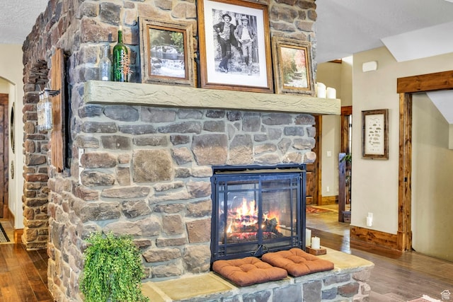 9049 N Timphaven Rd, Sundance, UT 84604 - room details with hardwood / wood-style flooring, a fireplace, and a textured ceiling
