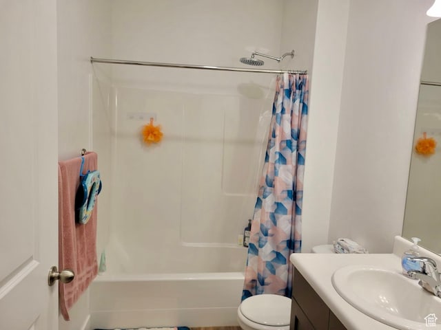 bathroom featuring vanity, toilet, and shower / tub combo