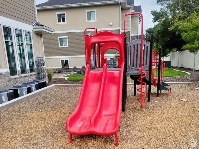 view of jungle gym with cooling unit and fence