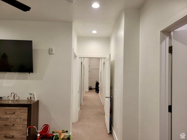 corridor with recessed lighting, baseboards, and light colored carpet