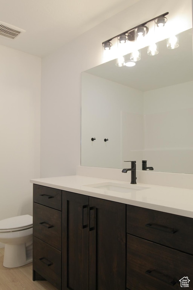 715 E 1250 S, Hyrum, UT 84319 - bathroom with vanity, toilet, and wood finished floors