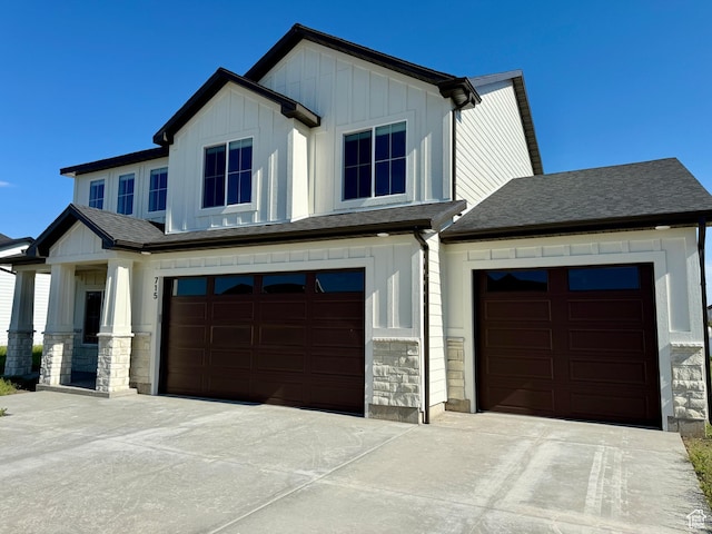 715 E 1250 S, Hyrum, UT 84319 - view of front facade with board and batten siding, stone siding, driveway, a garage, and a shingled roof