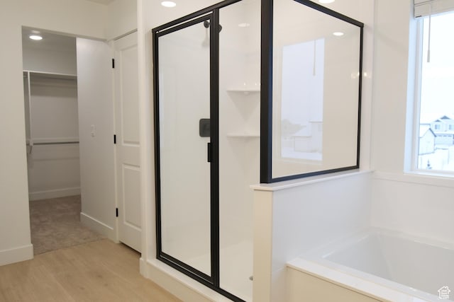 715 E 1250 S, Hyrum, UT 84319 - bathroom with a stall shower, a bath, wood finished floors, a walk in closet, and recessed lighting