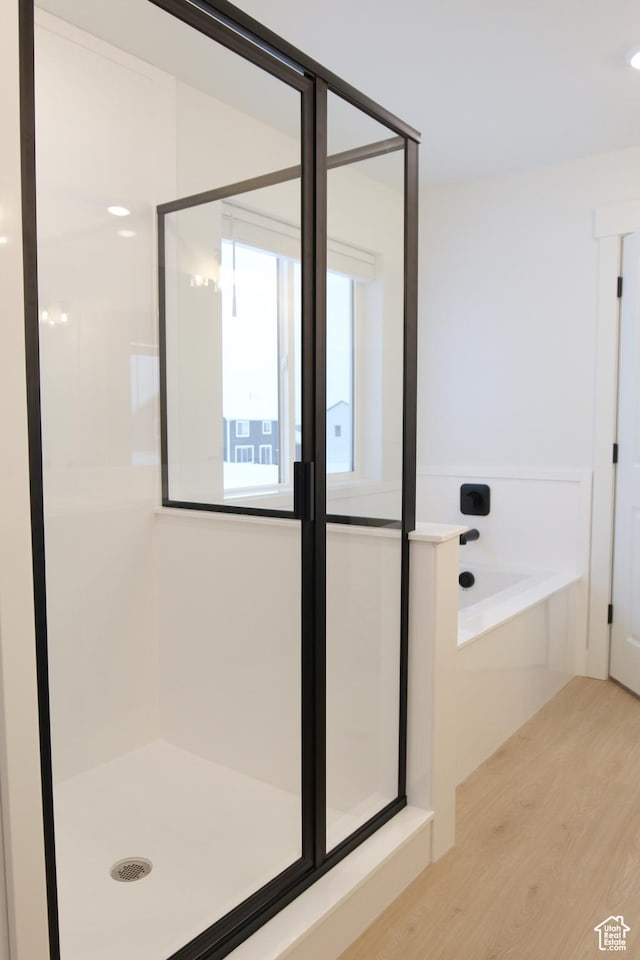 715 E 1250 S, Hyrum, UT 84319 - full bathroom featuring wood finished floors, a stall shower, and a bath