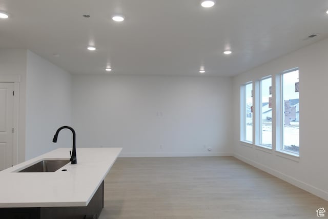 715 E 1250 S, Hyrum, UT 84319 - kitchen with a sink, light wood-style flooring, baseboards, recessed lighting, and light countertops