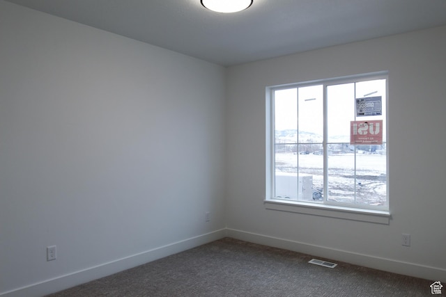 715 E 1250 S, Hyrum, UT 84319 - unfurnished room with plenty of natural light, baseboards, and dark carpet