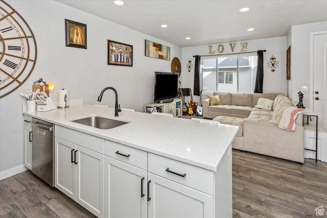 kitchen with dishwasher, dark wood-type flooring, white cabinets, sink, and kitchen peninsula