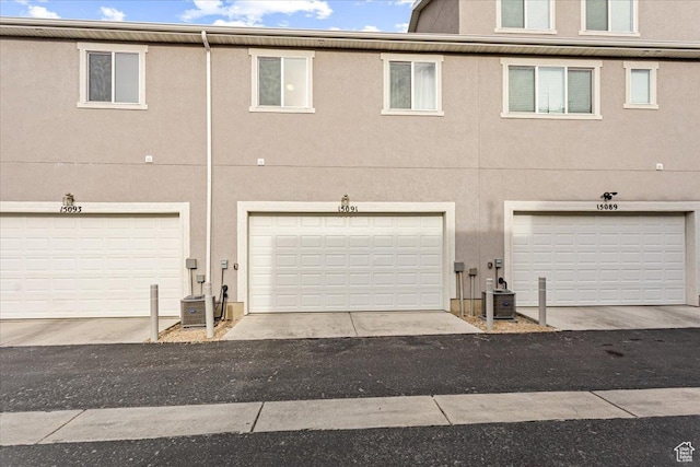 15091 S Reins Way W, Bluffdale, UT 84065 - rear view of property with stucco siding and a garage