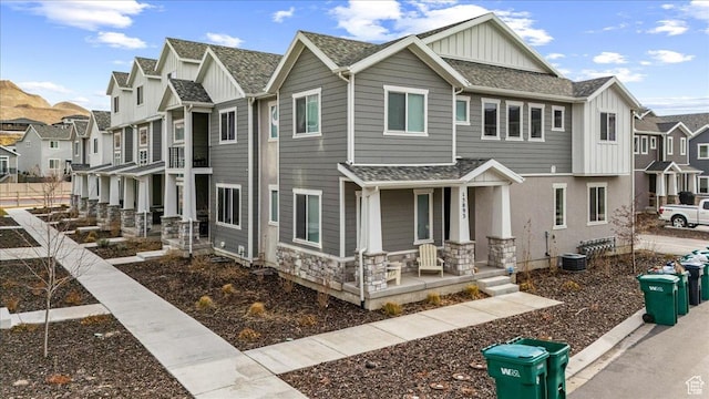 15091 S Reins Way W, Bluffdale, UT 84065 - view of front facade with a porch, board and batten siding, a residential view, and a shingled roof