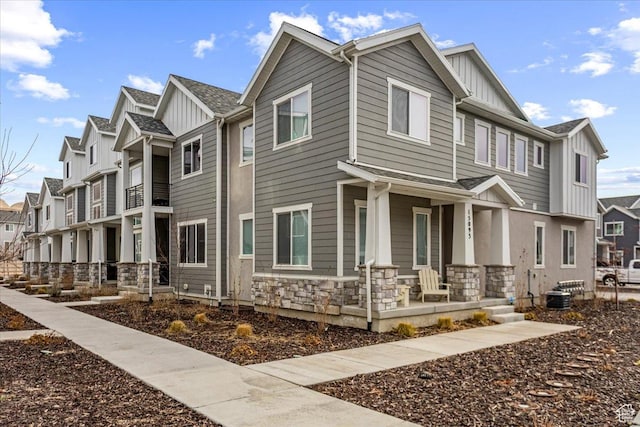 15091 S Reins Way W, Bluffdale, UT 84065 - view of front of home featuring covered porch, board and batten siding, stone siding, and a residential view
