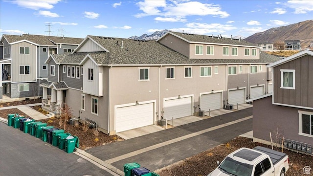 exterior space featuring a mountain view and central air condition unit