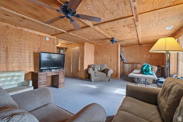 carpeted living room featuring wood ceiling and wood walls