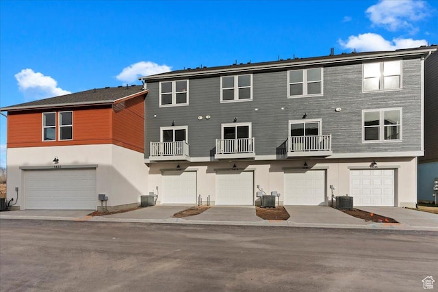 1414 N 1875 W # 131, Layton, UT 84041 - rear view of house with a garage, stucco siding, and central air condition unit
