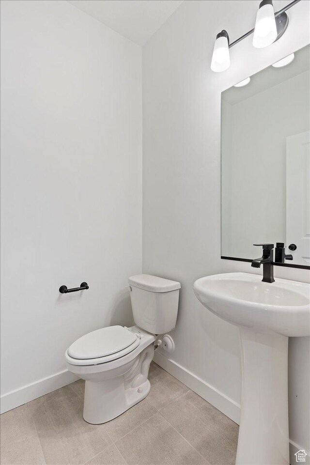 1414 N 1875 W # 131, Layton, UT 84041 - bathroom featuring baseboards, toilet, and a sink