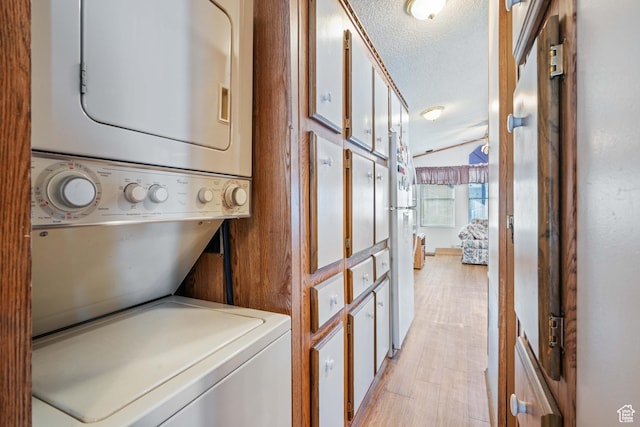 1150 W Red Hills Pkwy, Washington, UT 84780 - laundry room with a textured ceiling and stacked washer and dryer