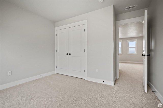 562 S 1140 E Unit 1206, Smithfield, UT 84335 - unfurnished bedroom with visible vents, baseboards, and light carpet