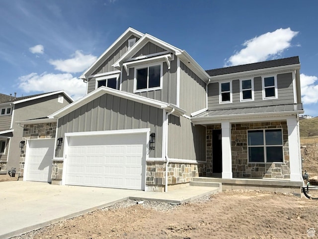 562 S 1140 E Unit 1206, Smithfield, UT 84335 - craftsman house with an attached garage, stone siding, covered porch, board and batten siding, and driveway