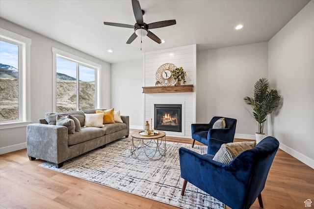 562 S 1140 E Unit 1206, Smithfield, UT 84335 - living room featuring a large fireplace, baseboards, ceiling fan, and wood finished floors